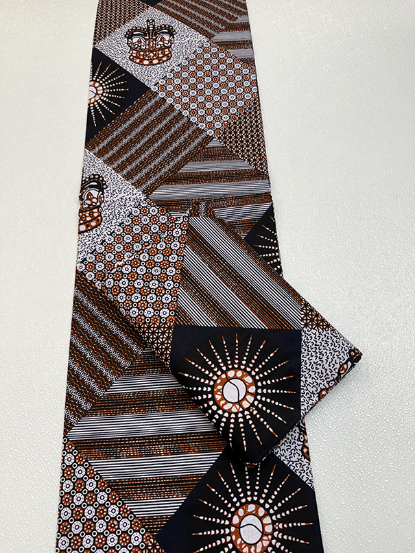 Hollandais Wax Print Fabric with geometric designs in brown, white, and black on a white background
