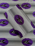 Patterned fabric with black and white stripes and purple circles featuring black birds on a white background.