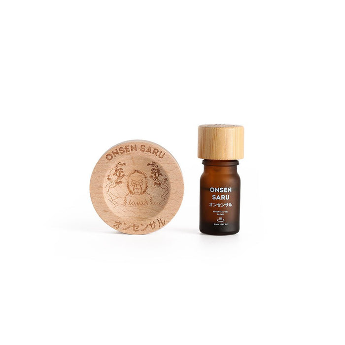 Onsen Saru essential oil blend with wooden cap and round wooden container on a white background