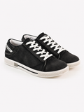 Black canvas sneakers with white laces and a textured finish, featuring a low-profile design and rubber sole.