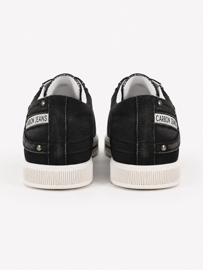 Black denim sneakers with white rubber soles and branded tags on the back, showcasing a casual style.