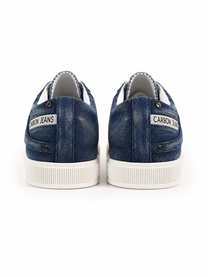 Denim sneakers with a white rubber sole, featuring a stitched design and label on the heel.