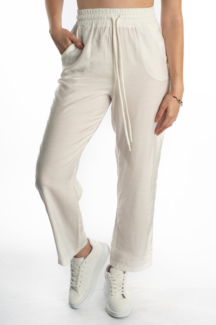 Kinley white wide-leg utility pants with high-waisted elastic drawstring waist and side pockets in a streetwear fit.