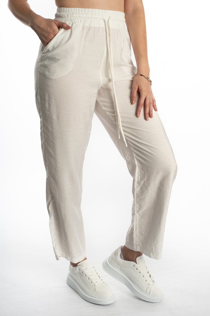 Kinley white wide-leg utility pants with elastic drawstring waist and side pockets for a streetwear aesthetic.