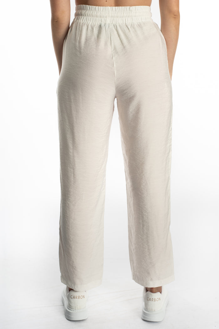 Rear view of Kinley white wide-leg utility pants featuring an elastic high waistband and relaxed streetwear fit on a model.