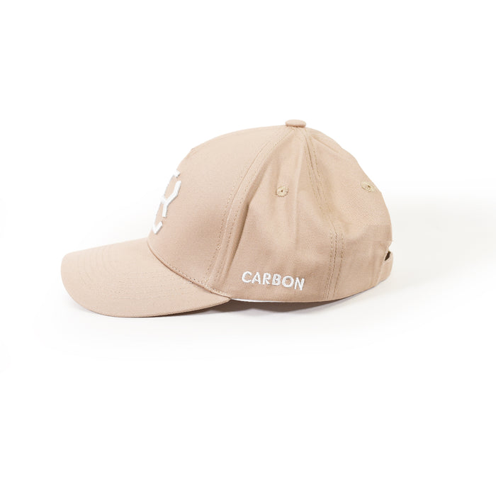 Side view of a tan Carbon streetwear baseball cap featuring white embroidered logos on a white background.