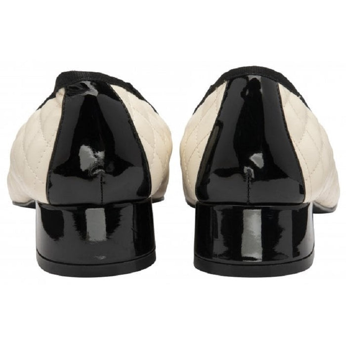 Women’s pumps back view: cream quilted uppers with black heel and patent toe