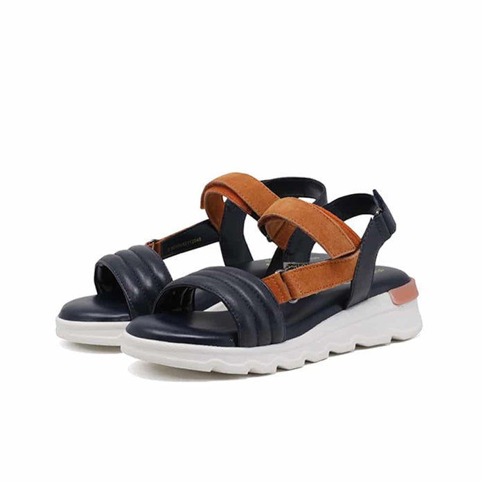 Women's blue leather sandals with tan cross straps and hook-and-loop closure, thick white sole