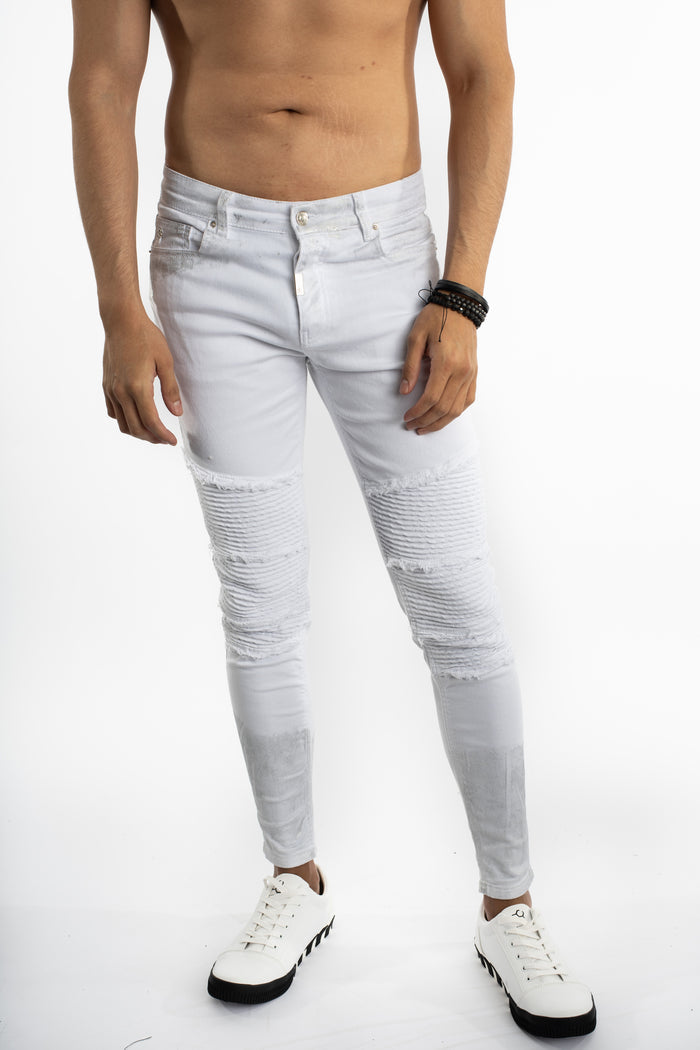 Luka White Slim Fit Jeans featuring distressed moto ribbing, tapered legs, and subtle paint splatter for a streetwear look.