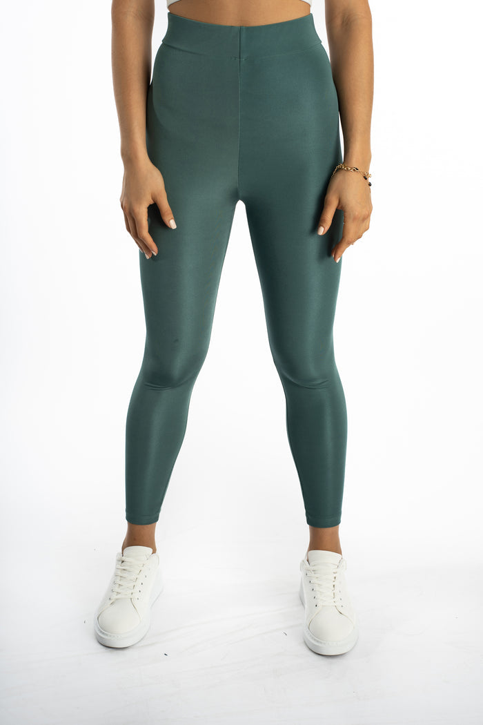 Maci high-waisted teal leggings in sleek athletic fabric, styled with white sneakers for an urban athleisure look.