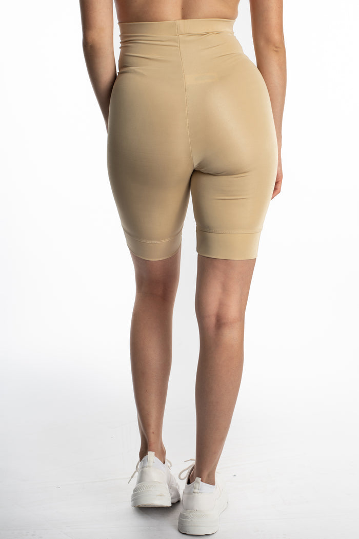 Rear view of Mara high-waisted beige biker shorts in seamless stretch fabric, ideal for athleisure and gym wear.