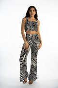Model in Marlee black knit crop top and matching tribal print flare pants for a streetwear aesthetic OOTD.