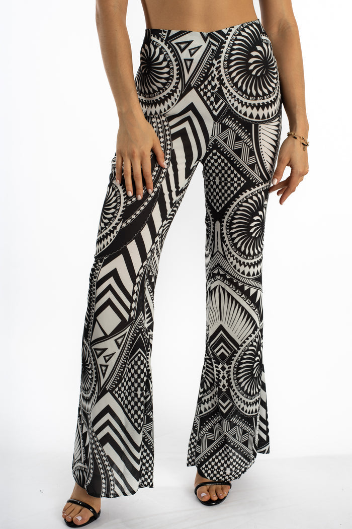 Marlee high-waisted wide-leg flare pants featuring a bold black and white geometric tribal bohemian print.