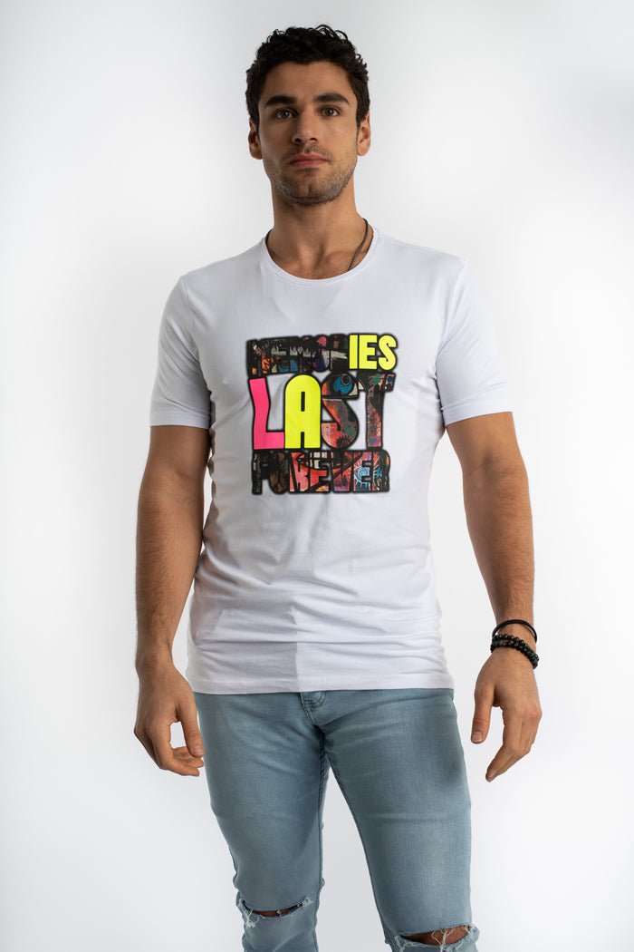 Man wearing white Memories Graphic T-Shirt with neon streetwear lettering and blue denim jeans.