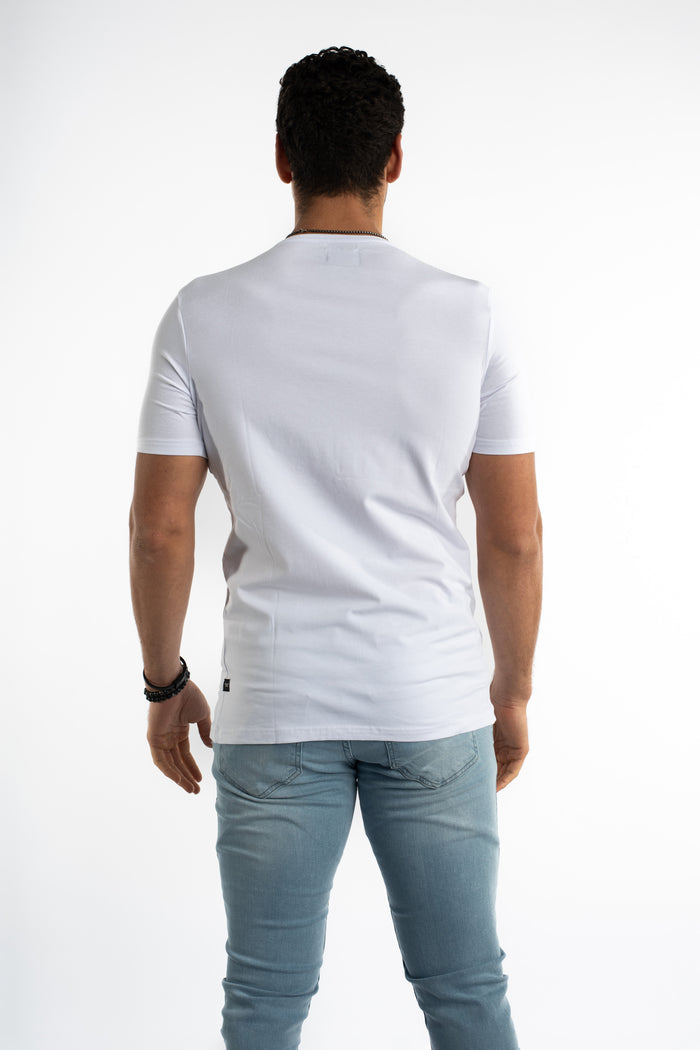 Back view of a man in the white Memories graphic t-shirt with an oversized streetwear fit and light wash denim jeans.