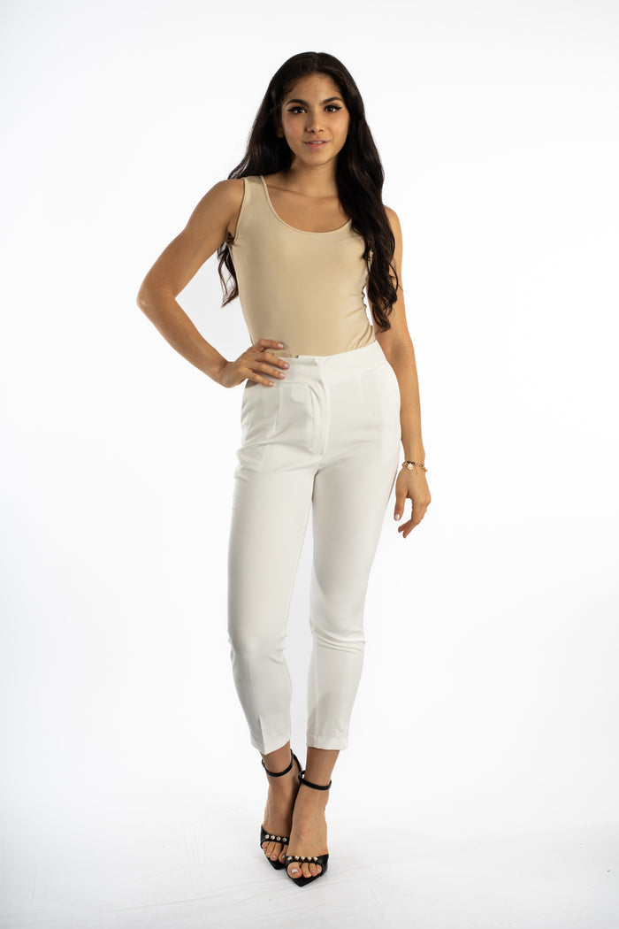 Model wearing the Noa Sleeveless Ribbed Bodysuit in beige with white high-waisted trousers and black heels.