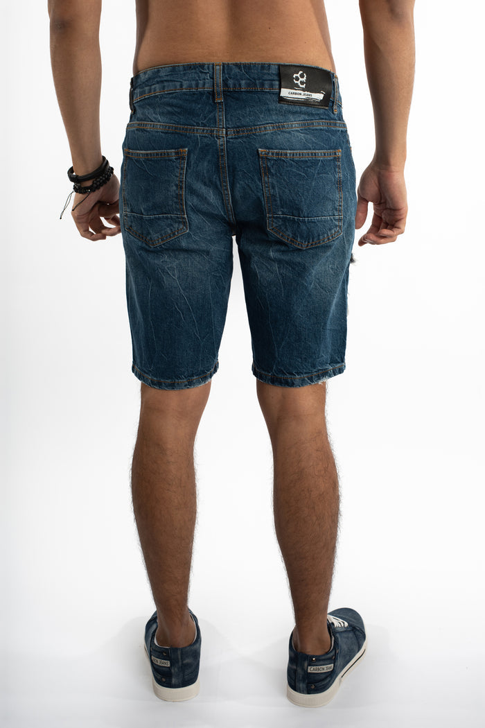 Back view of Otto Blue Distressed Denim Shorts for men featuring a Carbon Jeans logo patch and slim fit streetwear style.
