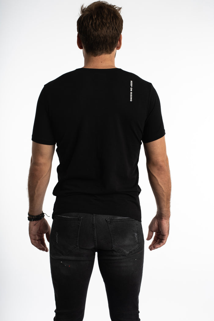 Rear view of the Painted King carbon black graphic streetwear tee with KEEP ON RISING text on the shoulder.