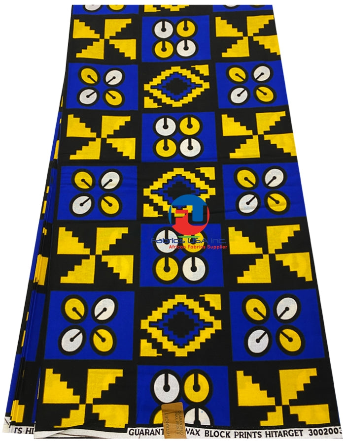 A piece of fabric with a geometric pattern in blue, yellow, black, and white colors, featuring a bird-like figure in the center.