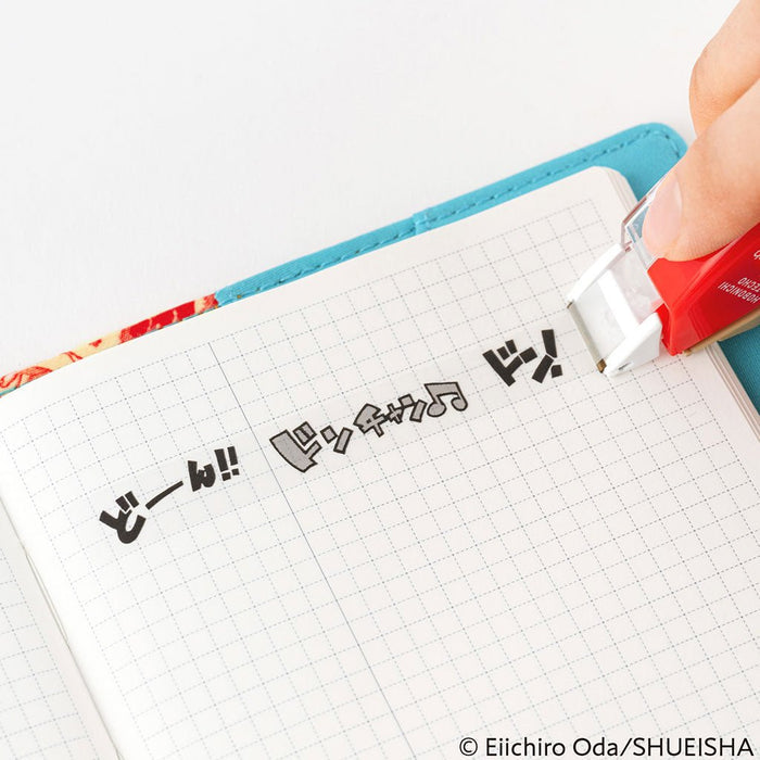 Row of tape with ONE PIECE characters on gridded planner page