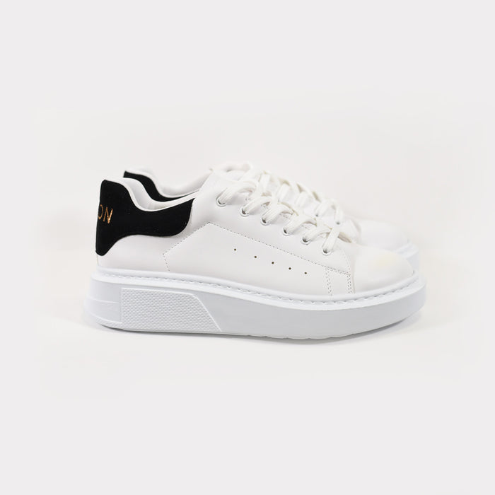 Queen white platform sneakers for women with chunky soles and black suede heel tabs by Carbon Jeans.