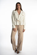 Model wearing Rhea White Denim Jacket with utility pockets, wooden buttons, and a cinched rope belt waist streetwear style.
