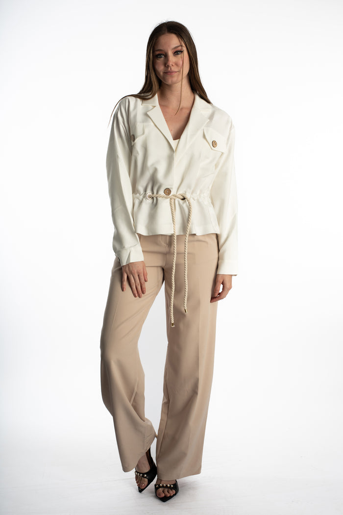 Model wearing Rhea White Denim Jacket with utility pockets, wooden buttons, and a cinched rope belt waist streetwear style.