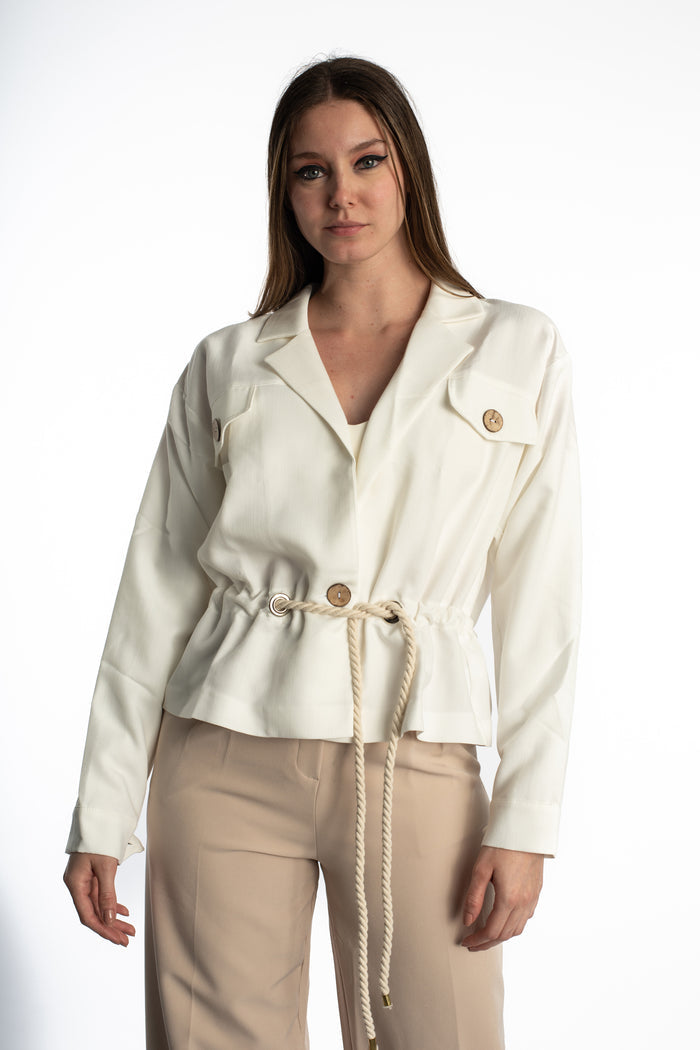 Model in Rhea white denim jacket featuring a streetwear vibe with a rope belt, utility pockets, and wood-style buttons.