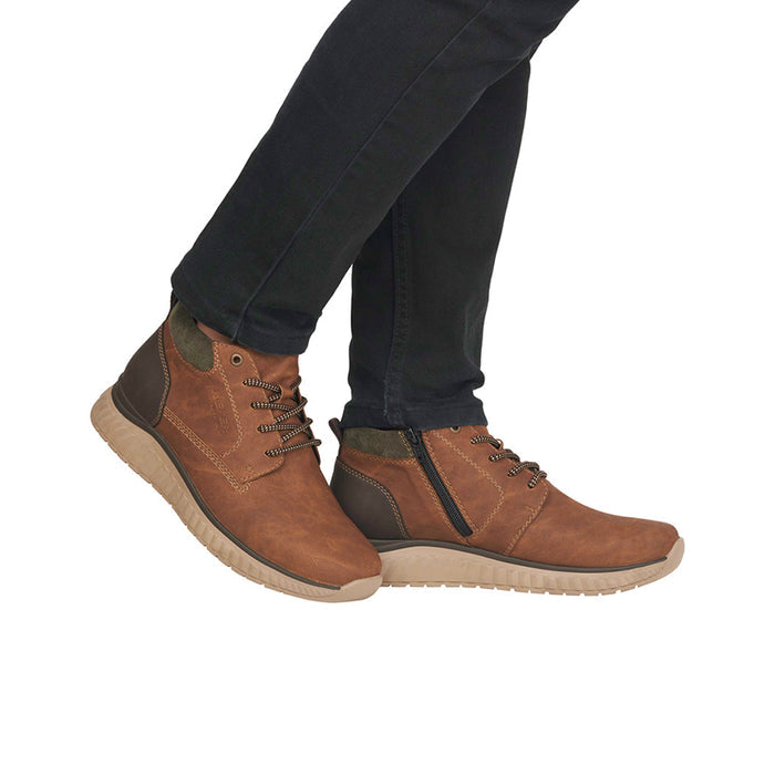 Men's brown casual boots worn with dark pants, lace-up design and textured sole
