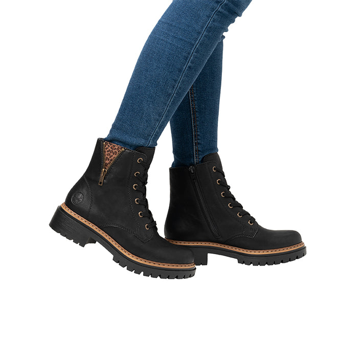 Black ankle boots with lace-up front, side zip, and chunky lug sole