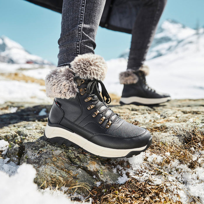Black winter snow boot with faux fur cuff, lace-up, and rugged thick sole.