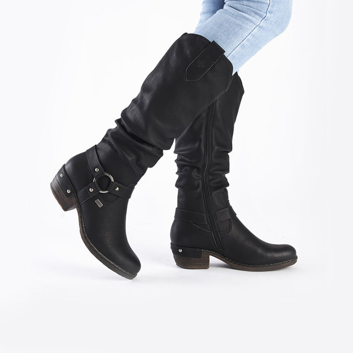 Black mid-calf zip boots with buckle strap and block heel worn with jeans