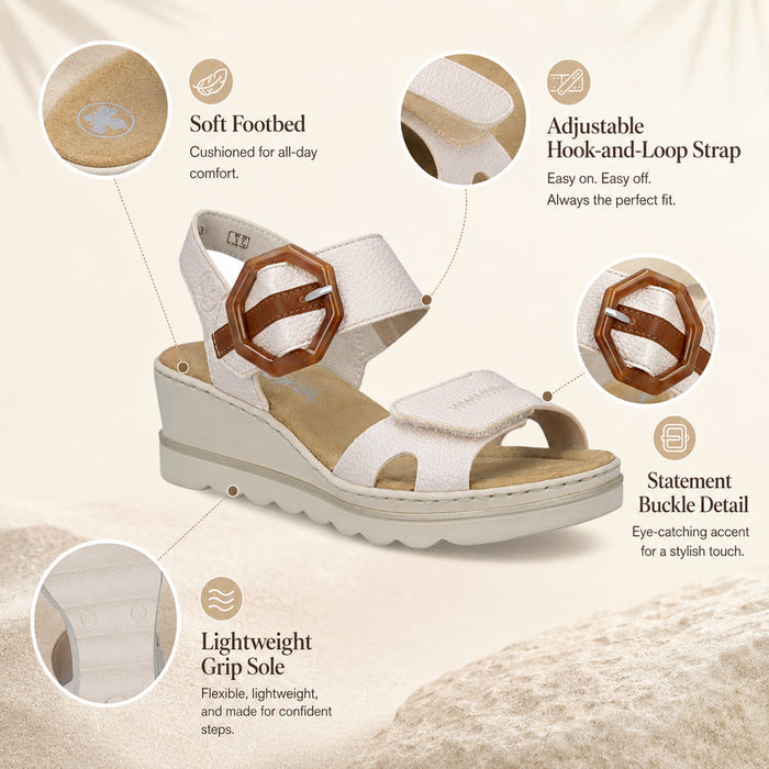 White wedge sandals with tan decorative buckle and hook-and-loop strap detail