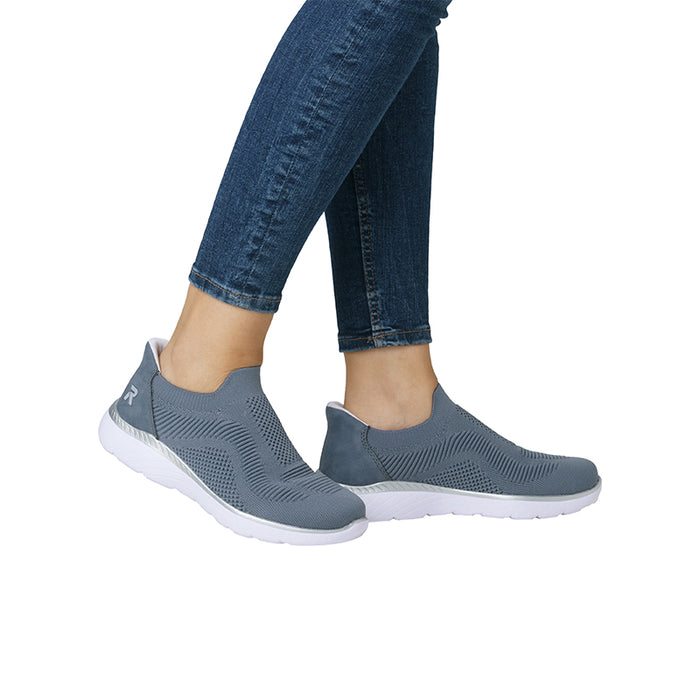 Blue knit slip-on sneakers shown on feet with white soles