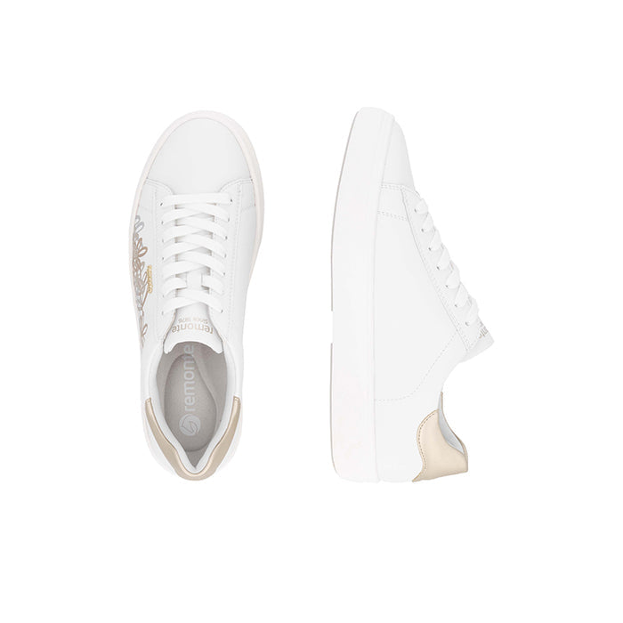 White lace-up sneaker pair view with beige trim and gold floral side embroidery.