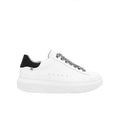 White lace-up sneakers with black heel and patterned black laces, chunky white sole