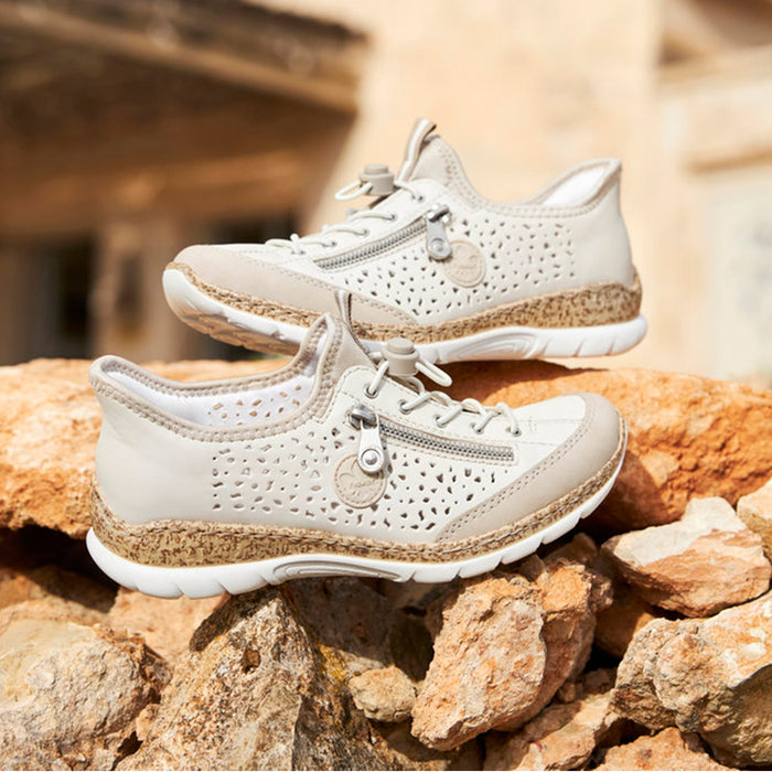 White perforated lace-up sneaker with cork-look midsole and textured outsole.