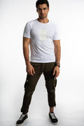 Man in a white Shadow Oversized Graphic Tee with olive cargo joggers, showcasing a minimalist urban streetwear style.