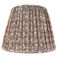Sophie in Pluff Reverse Pleated Lampshade — warm dark-ground repeating motif gathered into a tapered pleated lampshade; Hartman Lane