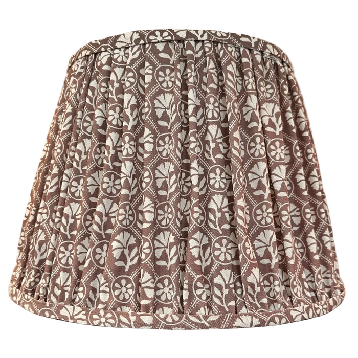 Sophie in Pluff Reverse Pleated Lampshade — warm dark-ground repeating motif gathered into a tapered pleated lampshade; Hartman Lane