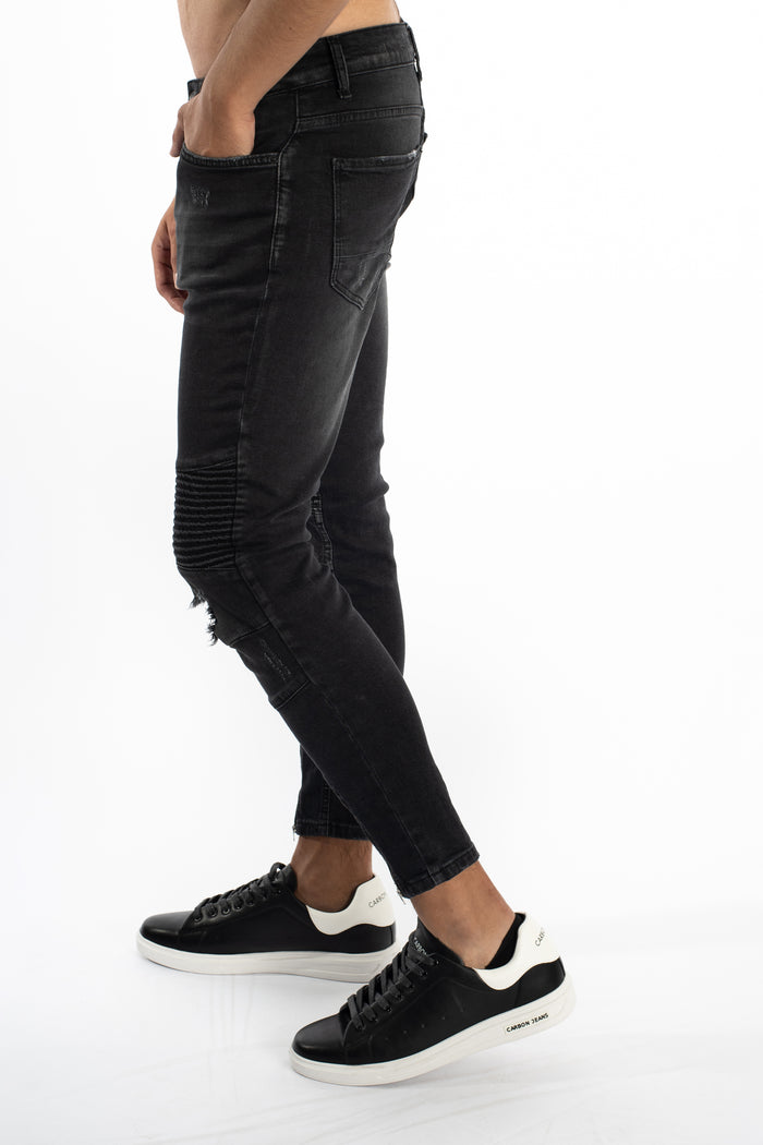 Side view of Soren black washed slim fit moto jeans with ribbed knee panels and distressed streetwear details.