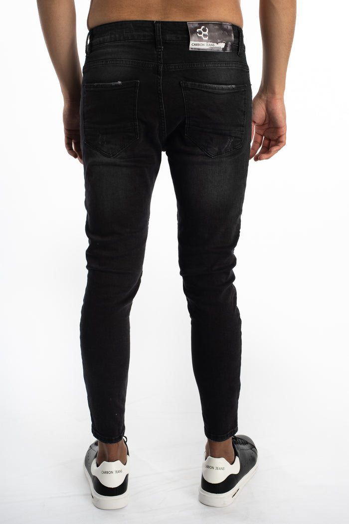 Back view of Carbon Soren black washed slim fit jeans for men with tapered legs and branded leather patch.