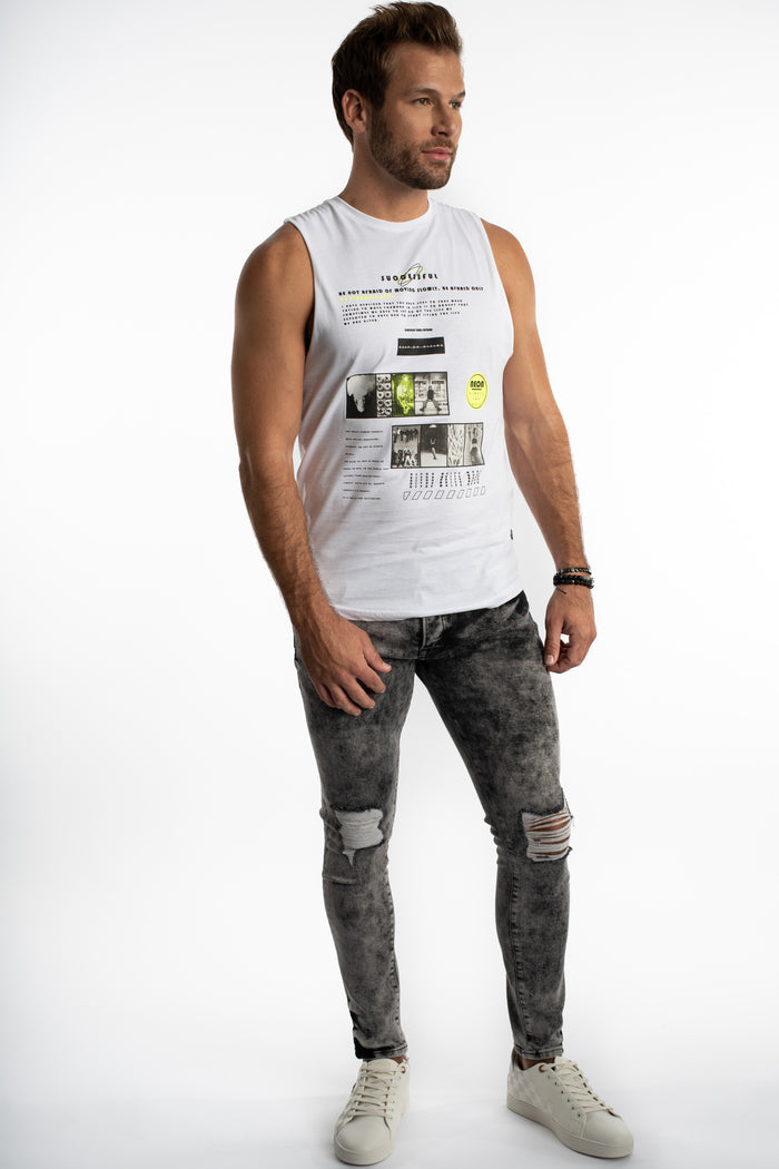 Model in a Successful white ribbed tank with streetwear graphics, paired with distressed grey jeans and white sneakers.