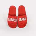 Red Carbon Jeans platform slide sandals with white block lettering and textured non-slip footbeds for summer.