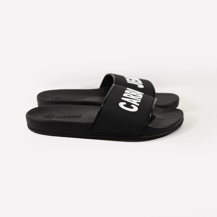 Carbon black platform flip flops for beach days, featuring white logo text straps and non-slip textured footbeds.