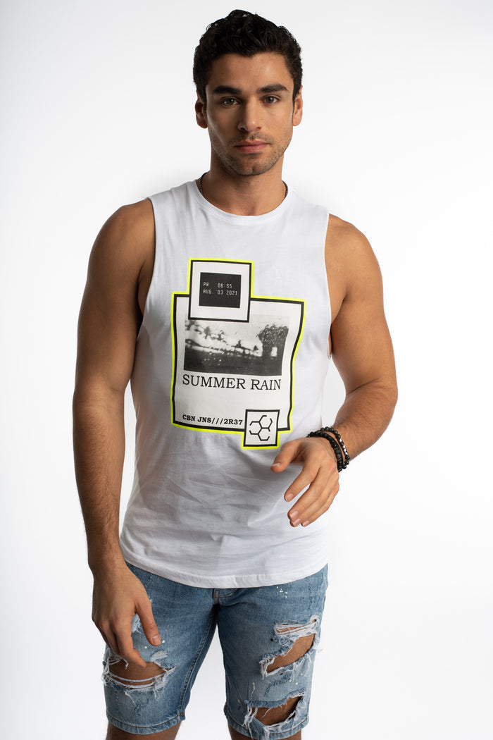 Man in Carbon Summer Rain white graphic muscle tank top with neon accents and slim fit distressed denim jeans.