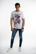 Men's white Teddyator cyborg bear graphic streetwear t-shirt styled with distressed blue jeans and white sneakers.