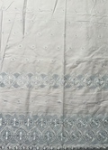 A piece of white Swiss Voile lace fabric with a delicate floral pattern and eyelet cut-outs.