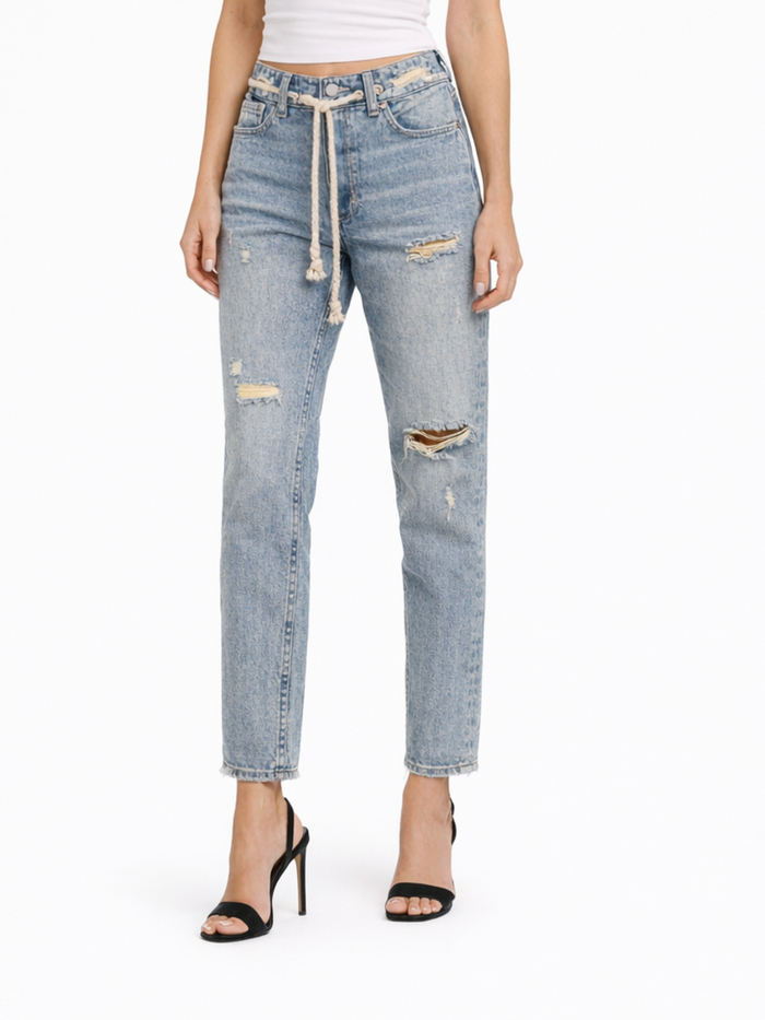 Light blue distressed jeans with a relaxed fit, featuring rips and a drawstring waist, paired with black heels.