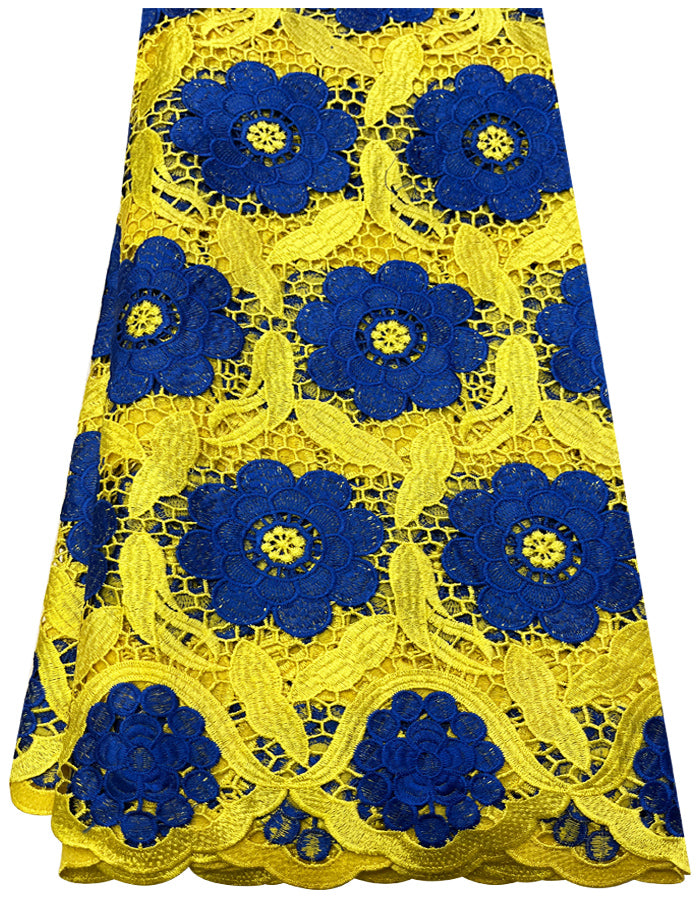 A piece of African lace fabric featuring yellow gold and royal blue colors with floral embroidery patterns.